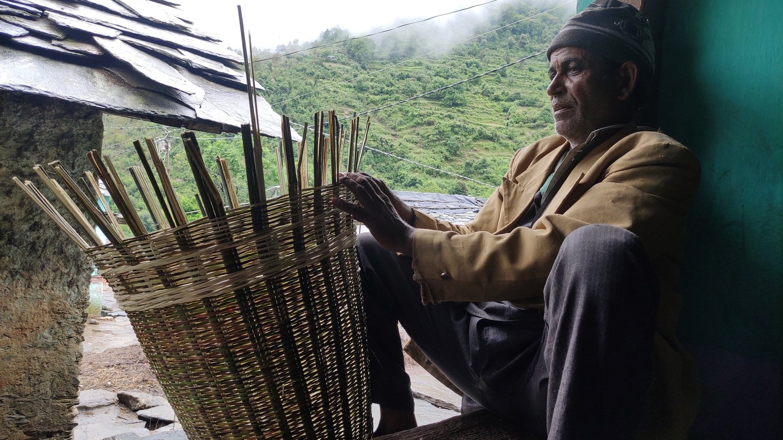 Elder craftsman weaving bamboo basket